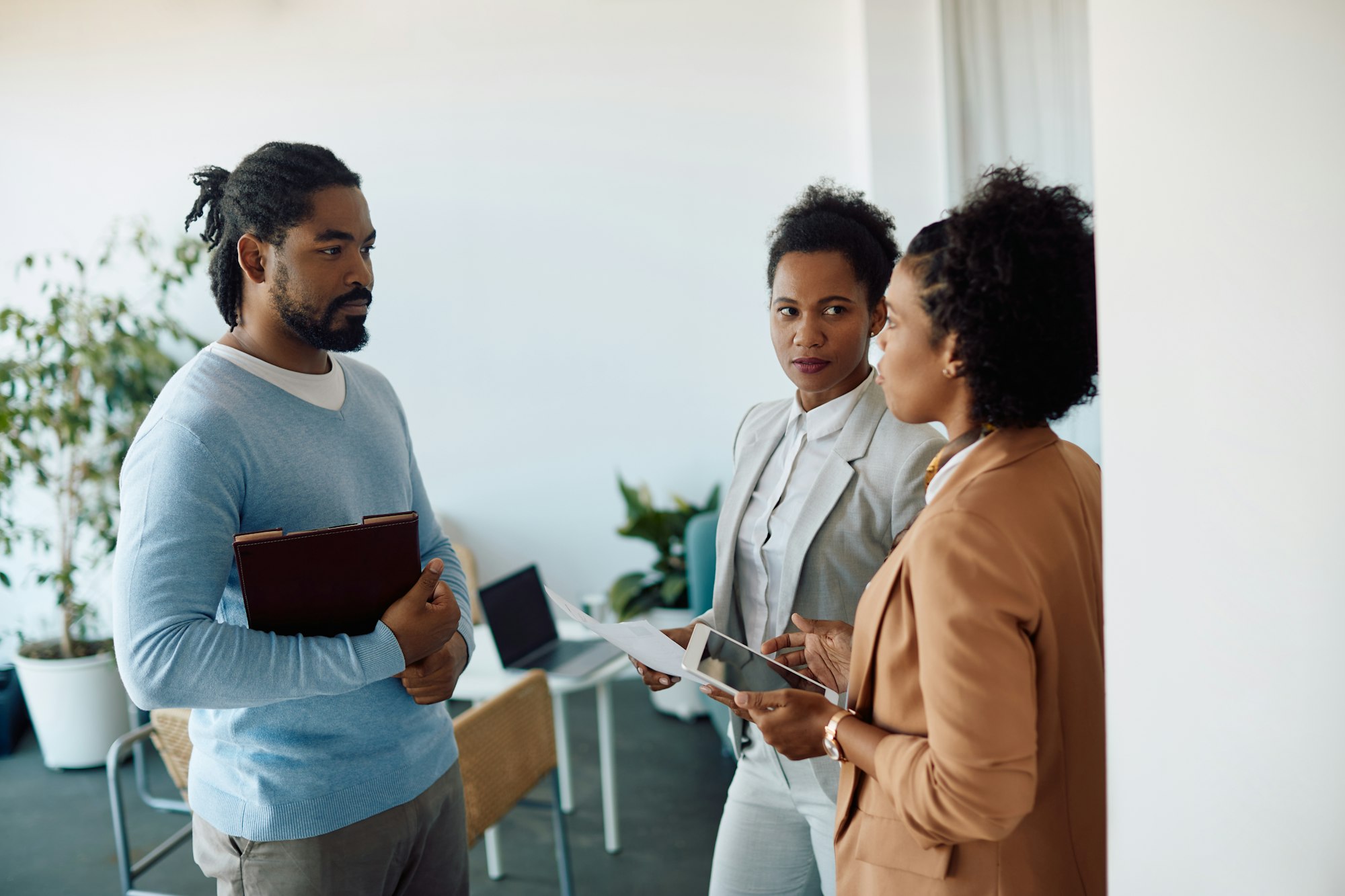 Group of African American entrepreneurs talking during business meting in the office.